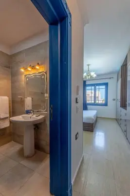 a bathroom with a sink and a bed in a room at Spacious villa with private pool in Hurghada