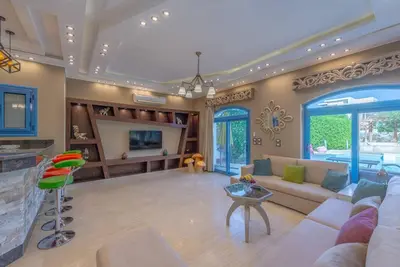 a large living room with a couch and a fireplace at Spacious villa with private pool in Hurghada