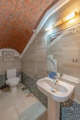 a bathroom with a sink and a toilet at Spacious villa with private pool in Hurghada