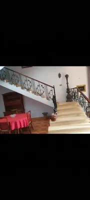 a staircase in a living room with a table and a table at Soliman Villa in Luxor
