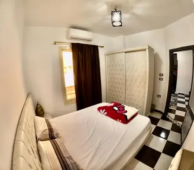 a bedroom with a bed with a teddy bear on it at hurghada home in Safaga