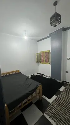 a bedroom with a bed and a rug at hurghada home in Safaga