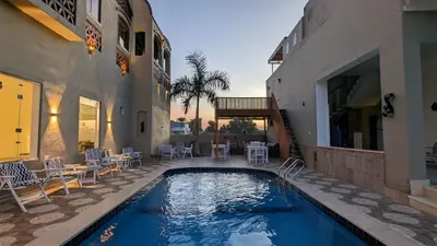 a swimming pool in front of a building at Yasmine Guest House in Luxor