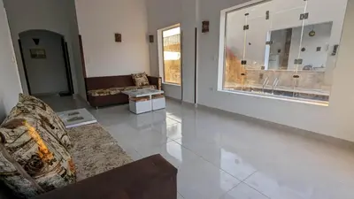 a living room with a couch and a large window at Yasmine Guest House in Luxor