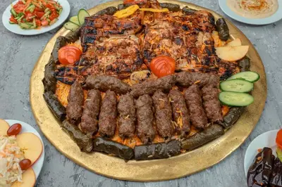 a plate of food with meat and vegetables on a table at Endo Mando in Shellal