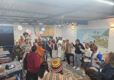 a group of people standing in a room with a cake at Endo Mando in Shellal