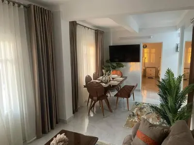 a living room with a table and a dining room at Tony HOUSE in Aswan