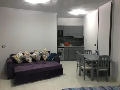 a living room with a purple couch and a table at Tiba view in Hurghada