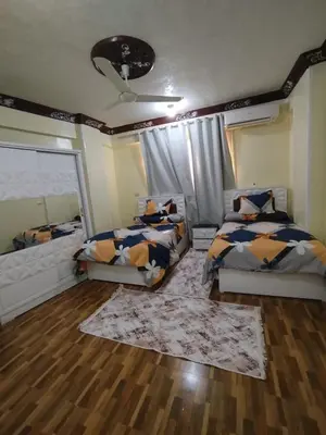 a bedroom with two beds and a window at شقة مميزة بجوار كورنيش النيل اسوان - عائلات فقط in Aswan