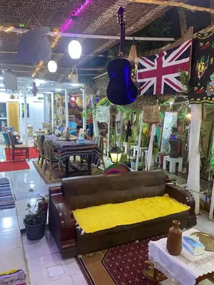 a living room with a couch and a table at peace garden hostel & camp in Luxor