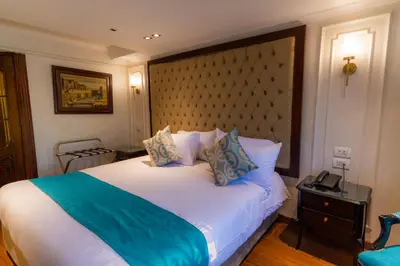 a bedroom with a large bed with a large headboard at Nile Cruise City and Sea Adonis - Every Thursday from Luxor for 04 or 07 Nights - Every Monday from Aswan for 03 Nights in Luxor