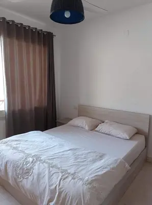a bedroom with a large white bed with a window at Al-hambra in Hurghada