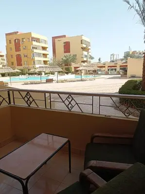 a balcony with a table and a view of a pool at Al-hambra in Hurghada