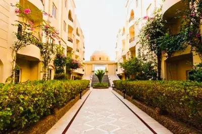a walkway in a building with a mosque in the distance at Apartment Sahl Hasheesh 1+1 in Hurghada