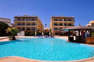 a large swimming pool in front of two buildings at Apartment Sahl Hasheesh 1+1 in Hurghada
