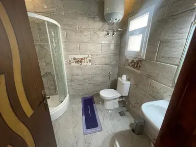 a small bathroom with a toilet and a sink at Marvel lotus in Hurghada