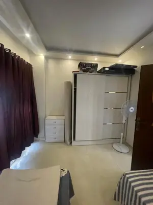 a bedroom with a bed and a closet with a door at Marvel lotus in Hurghada