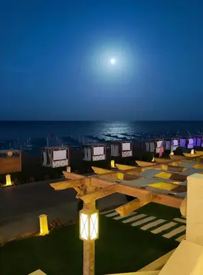 a view of a parking lot with the ocean in the background at luxury Beachfront Studio- Foreign Nationals Only in Hurghada