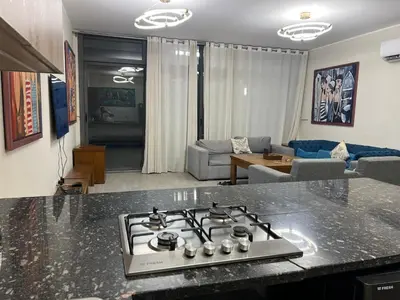 a kitchen with a stove top in a living room at Bali c 3 D in Hurghada