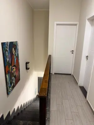 a hallway with a painting on the wall and a staircase at Bali c 3 D in Hurghada