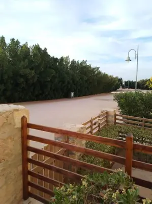 a wooden fence next to a dirt road at Mountain view apartment in Makadi Heights in Hurghada