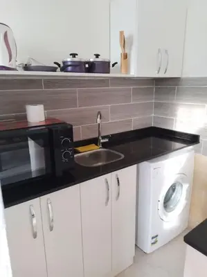 a kitchen with a sink and a microwave at Mountain view apartment in Makadi Heights in Hurghada