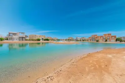 a view of the beach with buildings in the background at 4BR Villa with Private Pool Tawila Lagoon El Gouna in Hurghada