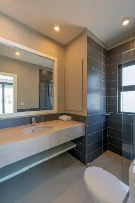a bathroom with a sink and a mirror and a toilet at 4BR Villa with Private Pool Tawila Lagoon El Gouna in Hurghada
