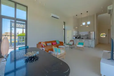 a living room with a table and a couch at 4BR Villa with Private Pool Tawila Lagoon El Gouna in Hurghada