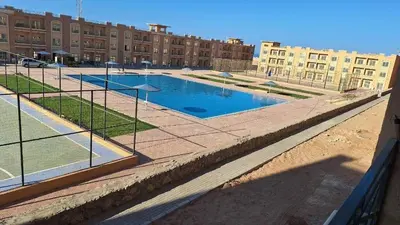 a swimming pool in the middle of a building at Bay View Sahl hasheesh Apartment Hurghada in Hurghada