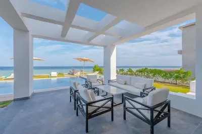 a dining room with a view of the ocean at Royal Villa on the beach in Hurghada