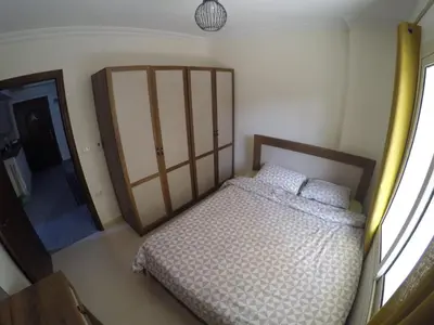 a small bedroom with a bed and a window at Andalusia Resort - 2 Bedroom Apartment in Hurghada