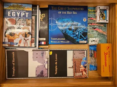 a bunch of books on a shelf at Pool View Studio with Wi-fi, Smart TV, 3 pools & beach access in Hurghada