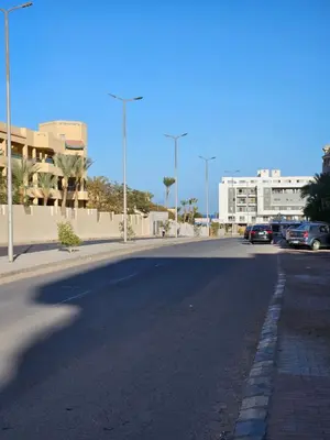 an empty street with cars parked in a parking lot at Pool View Studio with Wi-fi, Smart TV, 3 pools & beach access in Hurghada