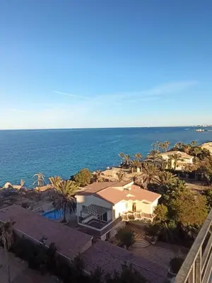 an aerial view of a house and the ocean at Juliana Beach Resort Hurghada in Hurghada