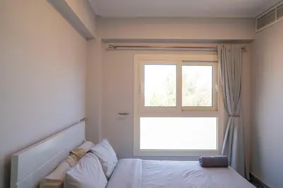 a bedroom with a bed and a window at MB1-1-104 in Hurghada