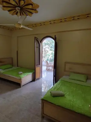 two beds in a room with an open doorway at Gabawy Garden Privatzimmer 2 Einzelbetten in Luxor