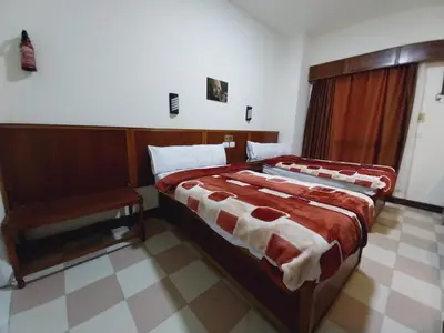 a bedroom with a large bed in a room at Merry Land Hotel & Roof Top Nile Restaurant Luxor in Luxor