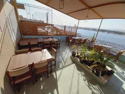 a restaurant on a boat with tables and chairs at Merry Land Hotel & Roof Top Nile Restaurant Luxor in Luxor
