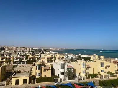 an aerial view of a city with houses and the ocean at Fanadir bay in Hurghada