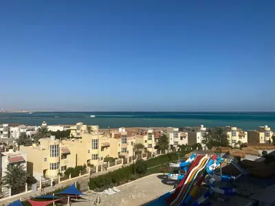 a beach with a bunch of water slides and buildings at Fanadir bay in Hurghada