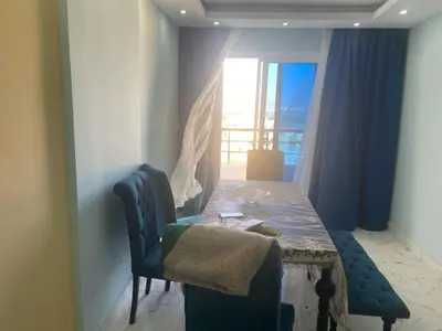 a dining room with a table and a window at Fanadir bay in Hurghada