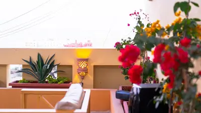a room with flowers in vases on a table at Lazur Sea & City Apartment's - El Hadaba, Hurghada - Egypt in Hurghada