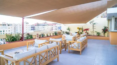 a restaurant with tables and chairs on a balcony at Lazur Sea & City Apartment's - El Hadaba, Hurghada - Egypt in Hurghada
