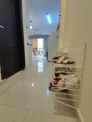 a shelf with shoes on it in a hallway at Studio Cleopatra Resort in Hurghada
