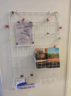 a towel rack on a tiled wall with books at Studio Cleopatra Resort in Hurghada