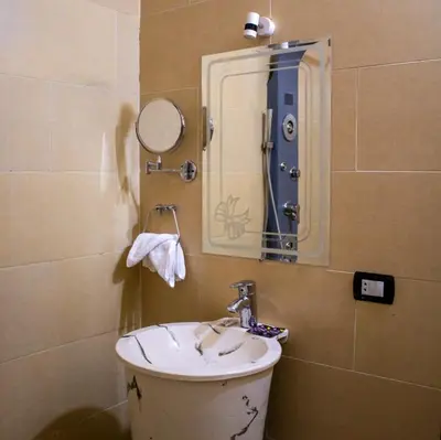 a bathroom with a sink and a mirror at ACHERTOD Nubian House in Naj‘ al Maḩaţţah