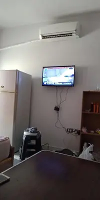 a room with a flat screen tv on a wall at Tibaview in Hurghada
