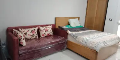a bed and a couch in a room at Tibaview in Hurghada