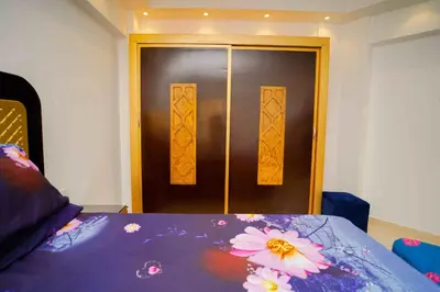 a room with a door with flowers on a bed at كمباوند فلورنزا خمسين in Hurghada